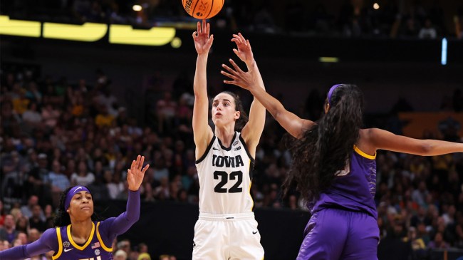 Caitlin Clark of the Iowa Hawkeyes shoots against Angel Reese of LSU