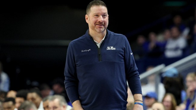 Chris Beard walks the sidelines during an Ole Miss basketball game.