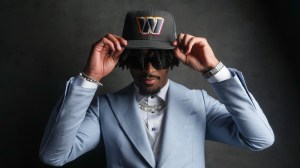 Jayden Daniels poses for a photo after being drafted by the Washington Commanders.