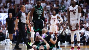Boston Celtics G Jayson Tatum lays on the floor after rolling his ankle during an NBA Playoff game vs. the Miami Heat.