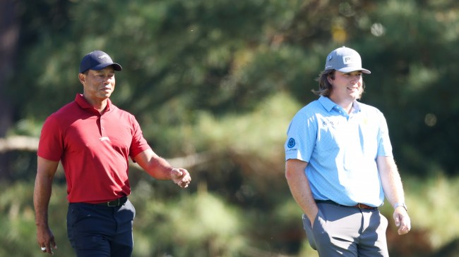 Neal Shipley walks alongside Tiger Woods at The Masters.