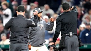 Umpires Todd Tichenor and Cory Blaser throw out manager Dave Martinez