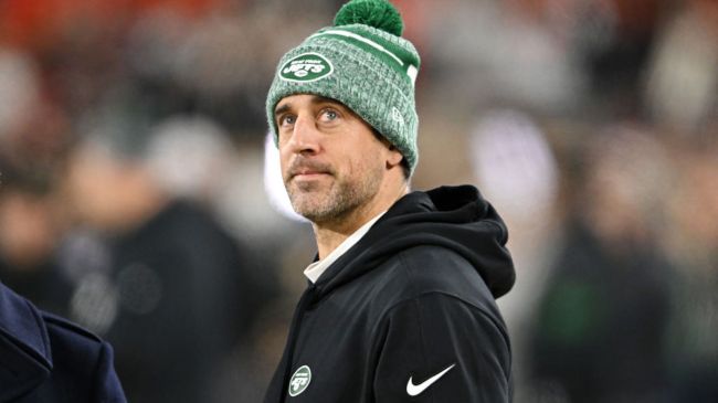 aaron rodgers wearing a green jets winter hat