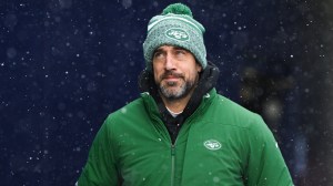 Aaron Rodgers runs onto the field for the New York Jets.
