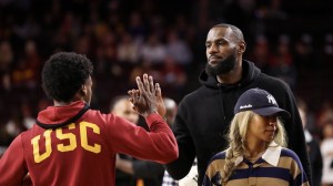 LeBron James high fives his son, Bronny, after a USC basketball game.