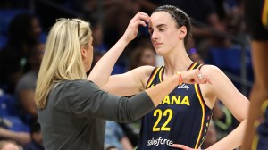 Caitlin Clark of the Indiana Fever talks to head coach Christie Sides