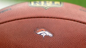 A Denver Broncos logo on a football.