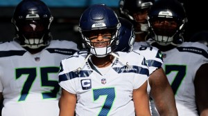 Seattle Seahawks QB Geno Smith leads his team onto the field.