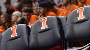 Illinois logos on a set of folding chairs at a basketball game.