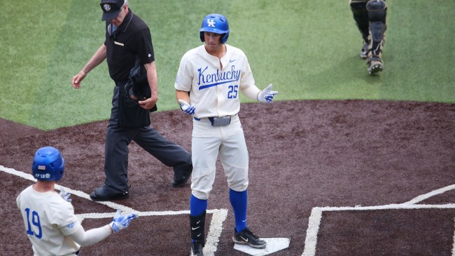 A Kentucky baseball player celebrates after hitting a home run.