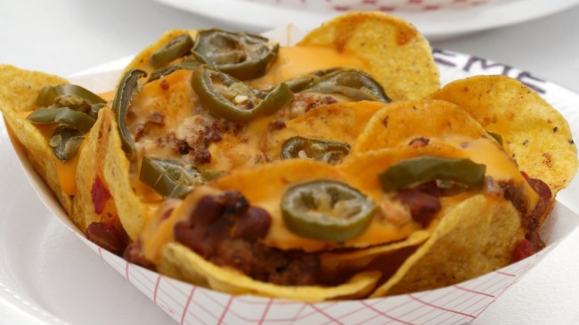 An image of nachos in a paper bowl.