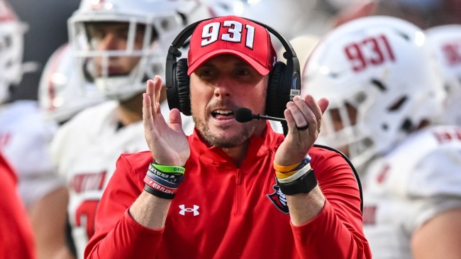 Austin Peay head coach Scotty Walden react on the sidelines during a football game.