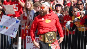 Travis Kelce with wrestling title belt during Chiefs Super Bowl Victory Parade