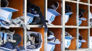 UNC baseball helmets in the Tar Heels dugout.