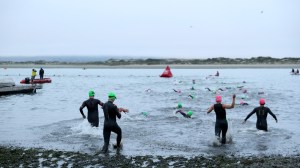 Ironman Morro Bay competitors entering treacherous swim course