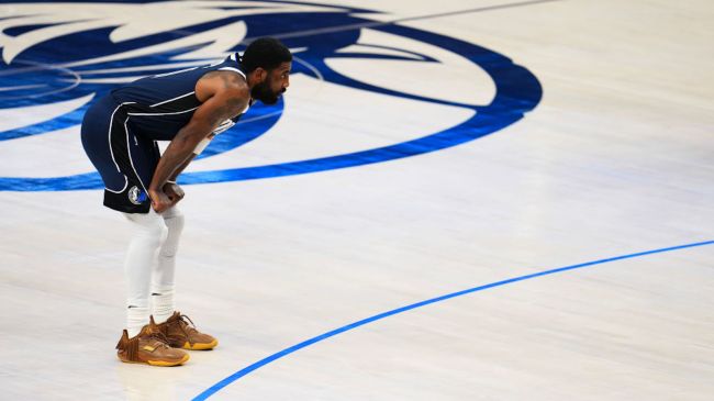 kyring irving leaning forward on a basketball court