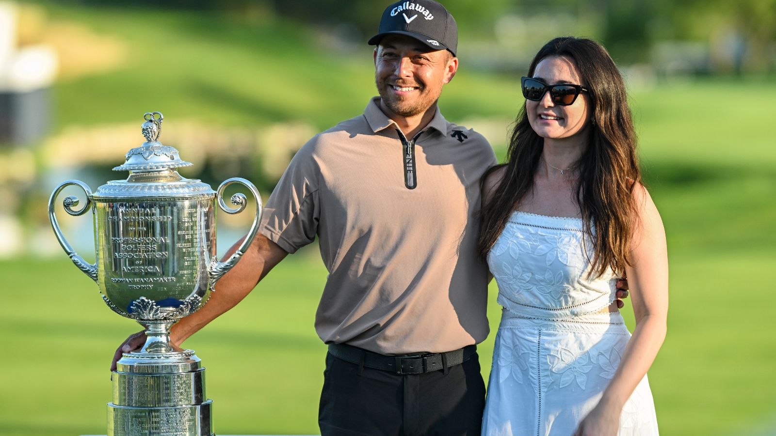 Maya and Xander Schauffele posing with the Wanamaker Trophy