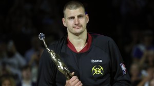 Nikola Jokic holding NBA MVP trophy