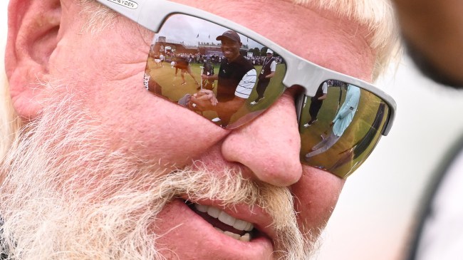 reflection of Tiger Woods in the glasses of John Daly