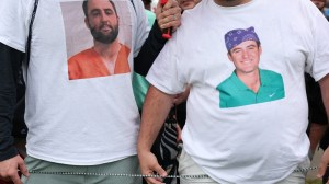 fans wearing Scottie Scheffler mugshot shirts