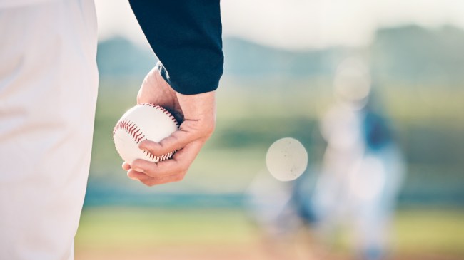 A pitcher holds a baseball on the mound.