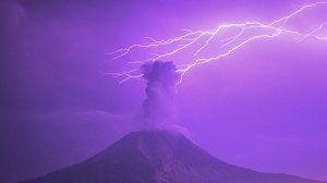 Volcano lightning over volcano plume during eruption
