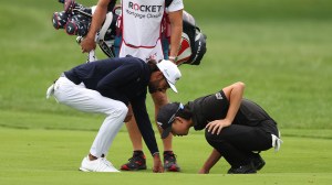 Akshay Bhatia looking for lost ball in drain at Rocket Mortgage Classic
