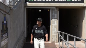 Coastal Carolina baseball coach Gary Gilmore walks onto the field at the College World Series.