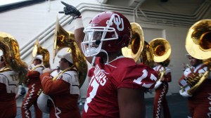 An Oklahoma football player flashes "Horns Down" by the Texas band.