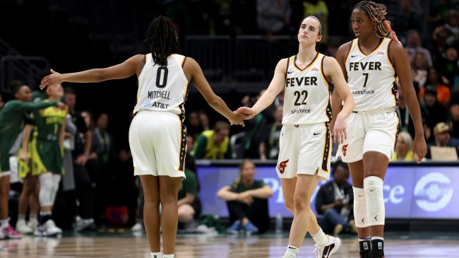 Indiana Fever players Kelsey Mitchell, Caitlin Clark, and Aliyah Boston on the floor.