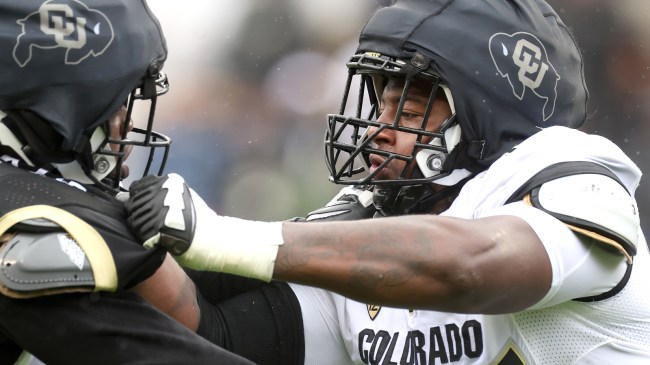 Colorado lineman Jordan Seaton blocks a defender at the Spring Game.