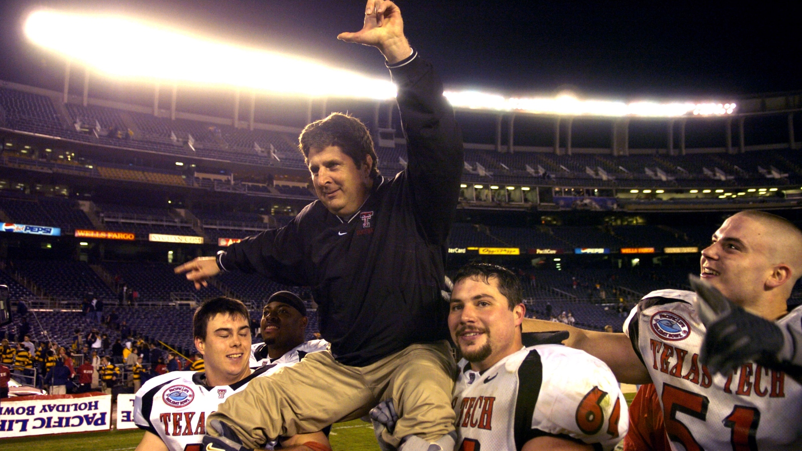 Texas Tech coach Mike Leach being carried off the field by his players