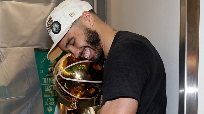 Jayson Tatum hugging Larry O'Brien Trophy