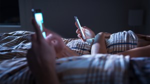 phone addiction couple in bed