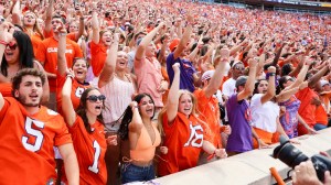 Clemson Tigers fans cheer during a football game.