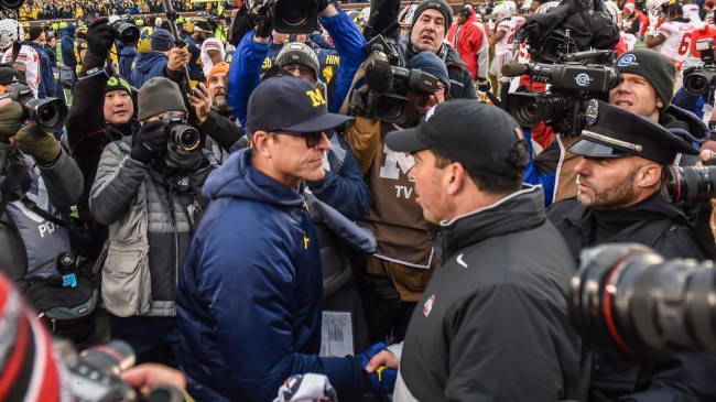 Jim Harbaugh and Ryan Day shake hands after a game between Michigan and Ohio State.