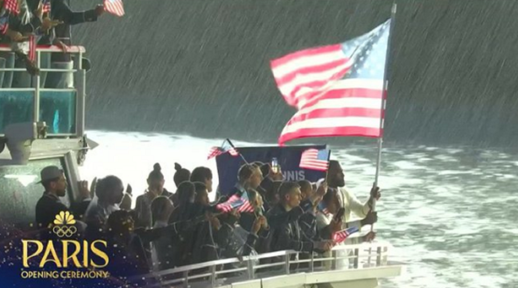 Photo Of LeBron James Holding American Flag While Rain Pours During