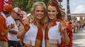 Texas Longhorns cheerleaders flash "Horns up,"
