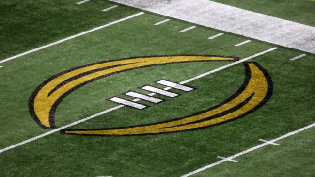 A College Football Playoff logo on the field at the Peach Bowl.