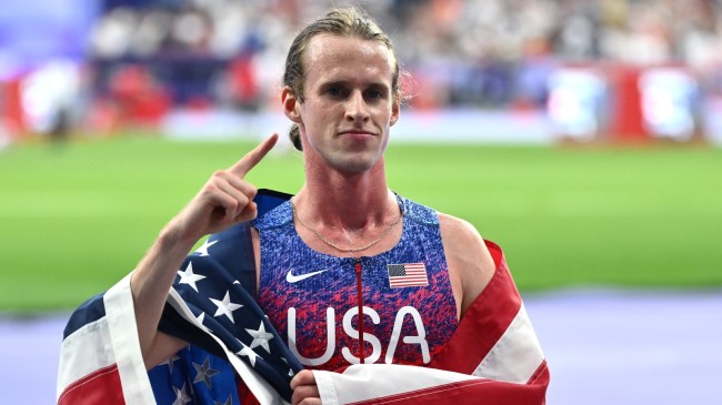 Cole Hocker celebrates after a win at the Olympics.