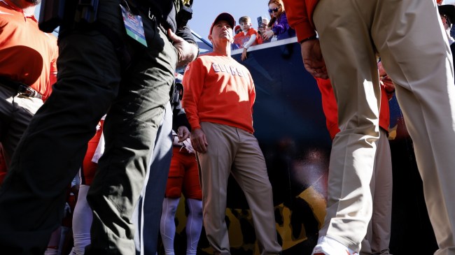 Dabo Swinney walks onto the field for a game between Clemson and Kentucky.