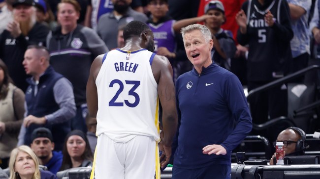 Draymond Green and Steve Kerr meet on the floor.