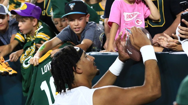 Green Bay Packers quarterback Jordan Love signs autographs during Family Night