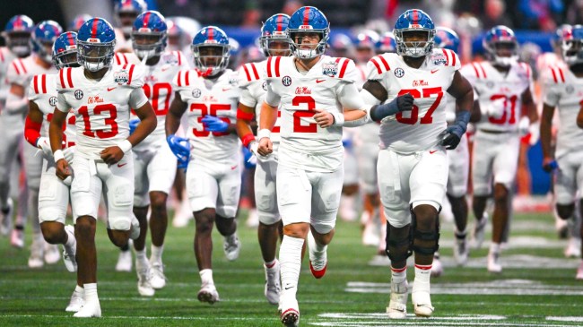 QB Jaxson Dart leads Ole Miss onto the field for its bowl game.