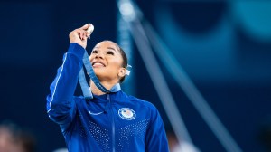 Jordan Chiles holds up her bronze medal at the Paris Olympics.