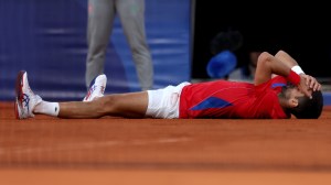 Novak Djokovic celebrates after winning gold at the Paris Olympics.