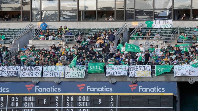 Oakland Athletics fans display their flags and signs while chanting sell the team