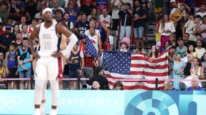 Fans wave an American flag at Team USA's basketball game vs. South Sudan.
