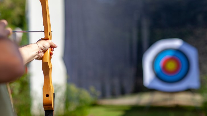 bow aiming at archery target