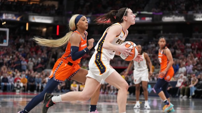 Caitlin Clark drives to the basket against Dijonai Carrington.